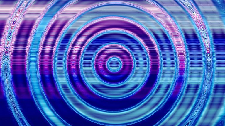 The water is rippling in a circular pattern, emanating from a central point. The hues of blue and purple dominate the image, with slight digital distortions added to the expanding ripples.